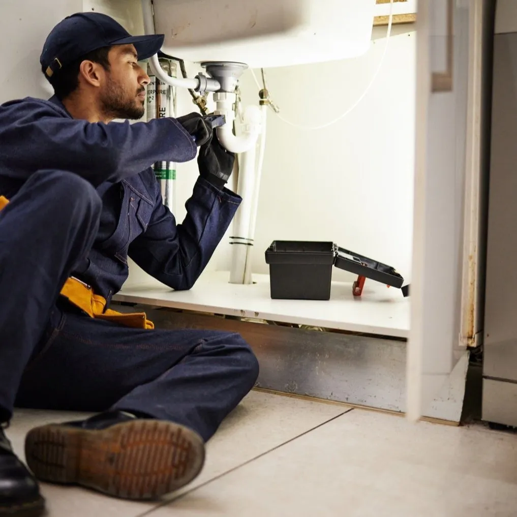 Skilled technician performing a professional pipe repair and installation in an Atlanta home